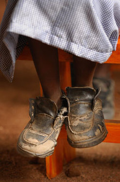 A child in beat-up shoes